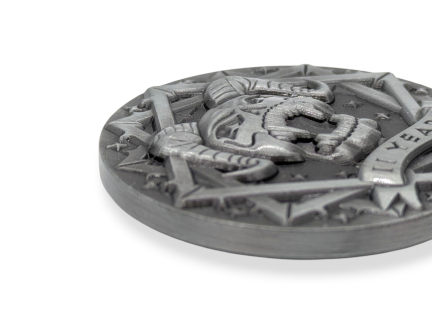 A close up of a custom challenge coin that shows the intricate details of a coin that has a satanic style design with a pentagram and horned skull.