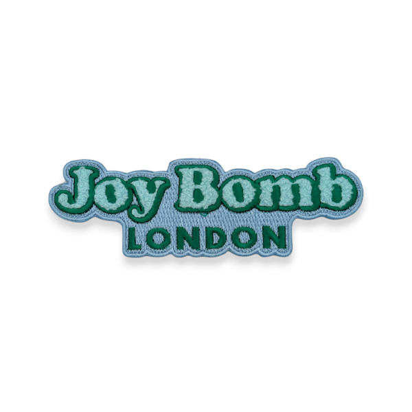 A turquoise chenille logo patch featuring the branding of