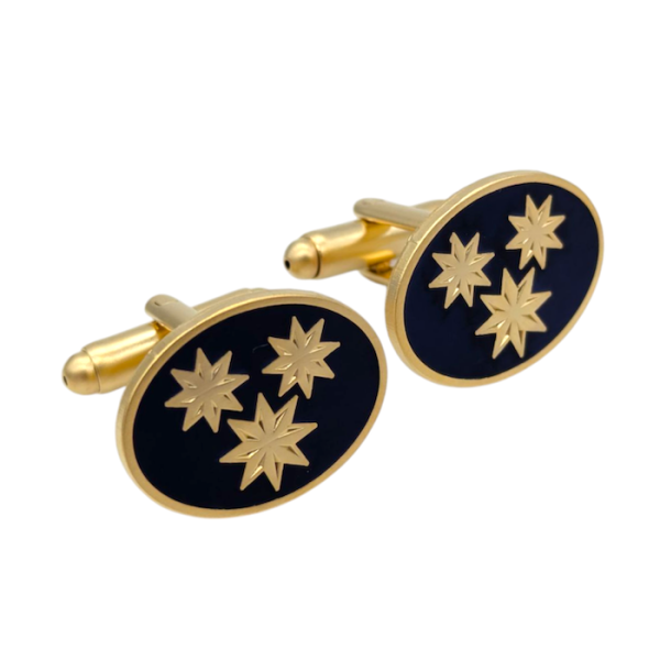 Gold-plated custom cufflinks with a black enamel background and three gold stars on each cufflink.