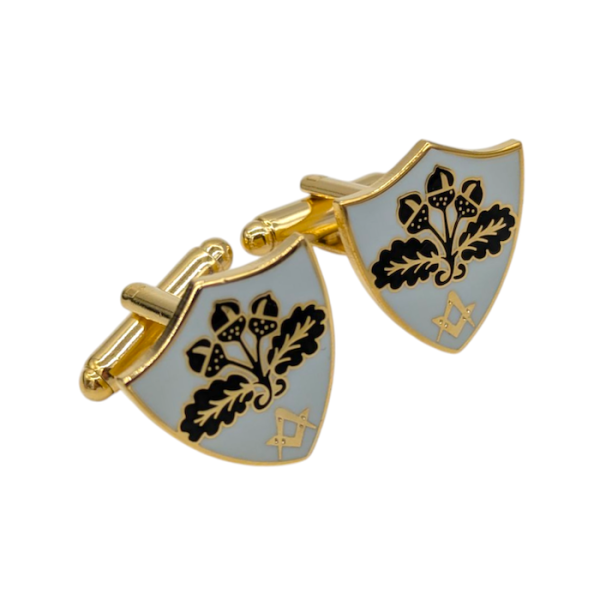 Shield-shaped gold cufflinks with a black acorn logo and a gold masonic symbol underneath.