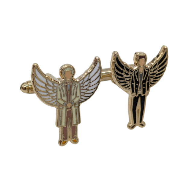 Bespoke cufflinks featuring two angels. One cufflink has a man wearing a long beige overcoat and white wings, the second cufflink is almost the same design, but instead this angel is wearing a black jacket and black wings.