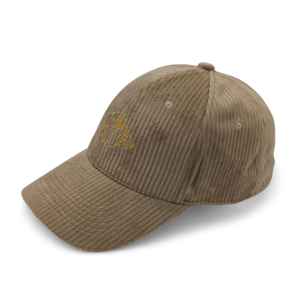A brown corduroy baseball cap with a crossaint logo embroidered onto the front.