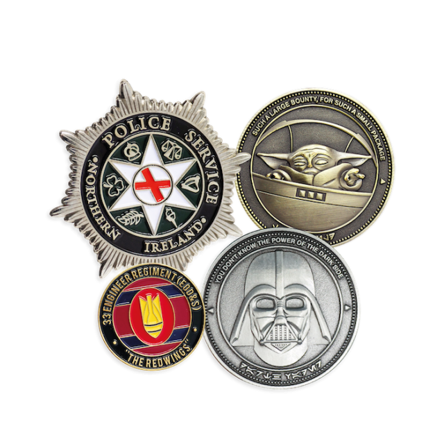 Four custom challenge coins. One star shaped coin for the police service, a gold die-struck coin featuring Grogu from The Mandalorian, a silver die-struck coin featuring Darth Vader's helmet, and a colorful soft enamel coin for a firefighters coin.