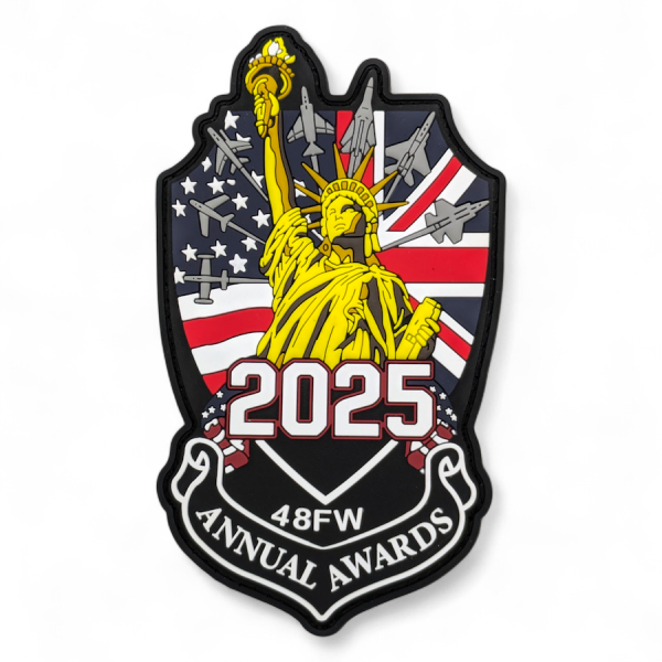Custom PVC patch shaped badge with yellow Statue of Liberty, 2025 text, 48FW annual awards ribbon, US and UK flags with fighter jets background.