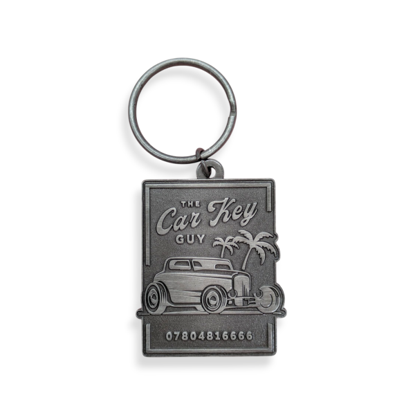 A rectangular nickel plated dies-struck keyring with a classic car on the front.