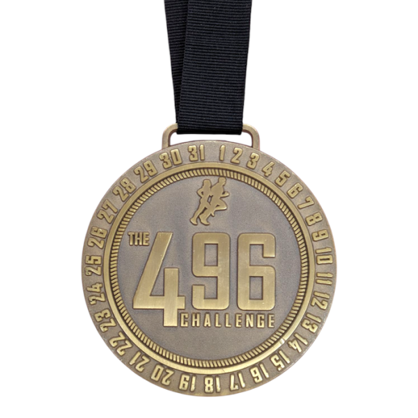 A massive running medal with a weathered gold-plated effect attached to a black ribbon.