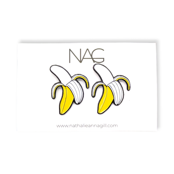 A pair of soft enamel banana earrings attached to a custom earring backing card.