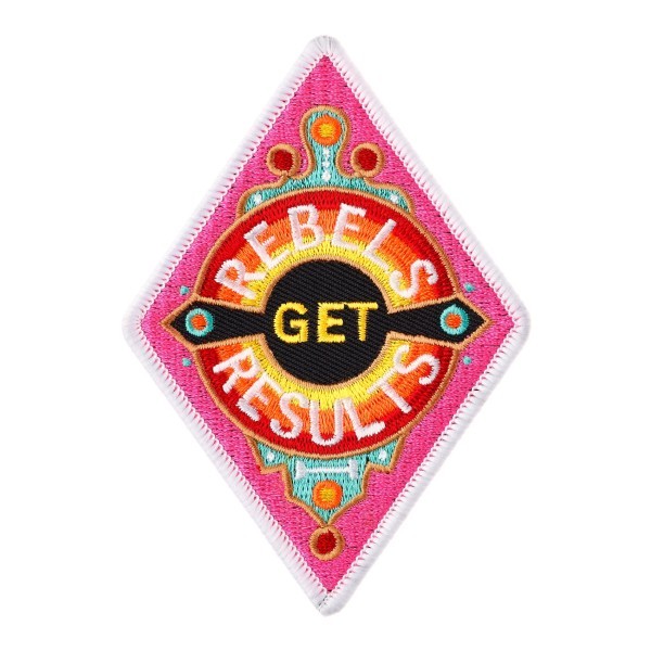 A diamond shaped custom embroidered patch with vibrant pink, orange, and yellow threads. The words