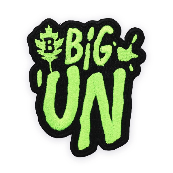 Bold embroidered patch with bright green “Big Un” text on a black background, stitched for high contrast and impact, ideal as a custom embroidered patch for statement designs, branding or novelty embroidered patches.