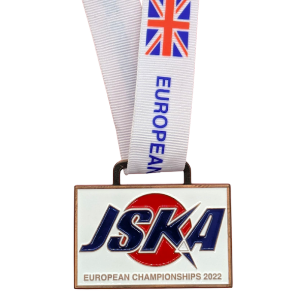 A white rectangular custom enamel medal with the Japanese flag in the background and the words