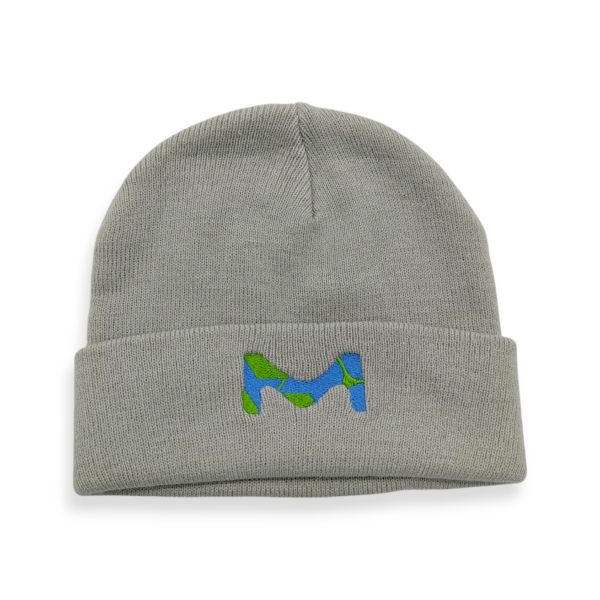 A grey knitted beanie hat with a blue embroidered 'M' logo.