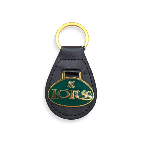 A black bespoke leather fob keyring with a green Lotus enamel badge on the front.