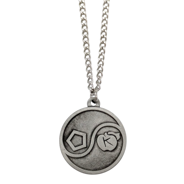 A nickel plated custom chain and pendant. The pendant is circular and has the ying/yang pattern with a hexagon on one side and an apple with a K in it so it looks like it says OK on the pendant.