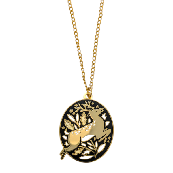 A gold-plated pendant necklace. The oval-shaped pendant has a black background and a gold leaping stag surrounded by white flowers.