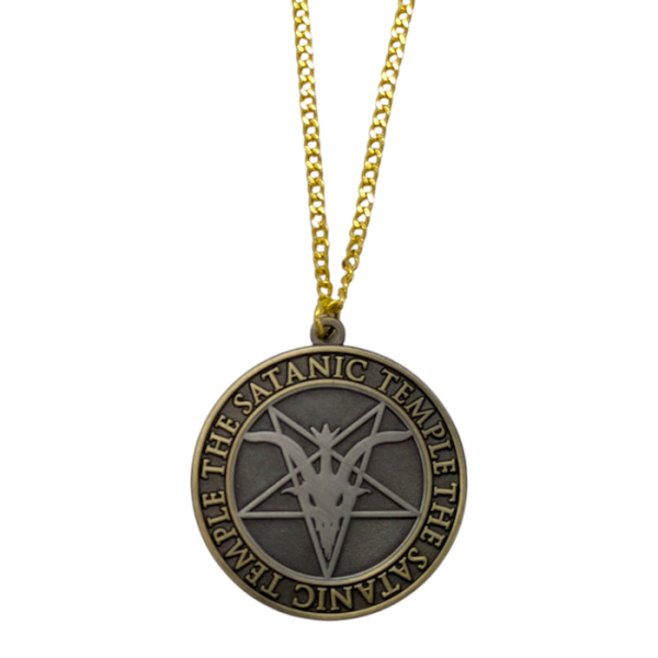A large antiqued gold plated pendant and chain. The circular pendant features a pentagram, horned goats skull and the words