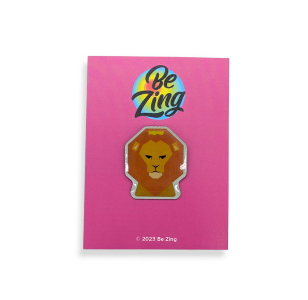A pink backing card with a lion's head printed badge attached to it.
