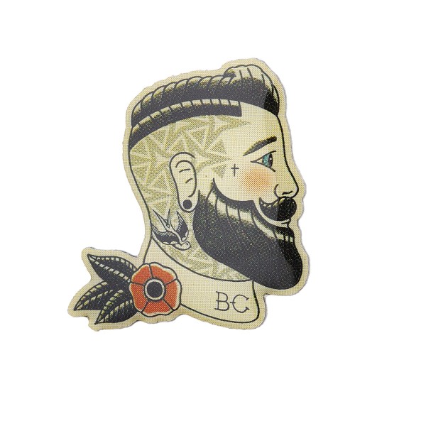 A printed pin of a freshly trimmed bloke with a clean-cut beard, neck scarf and tattoos.