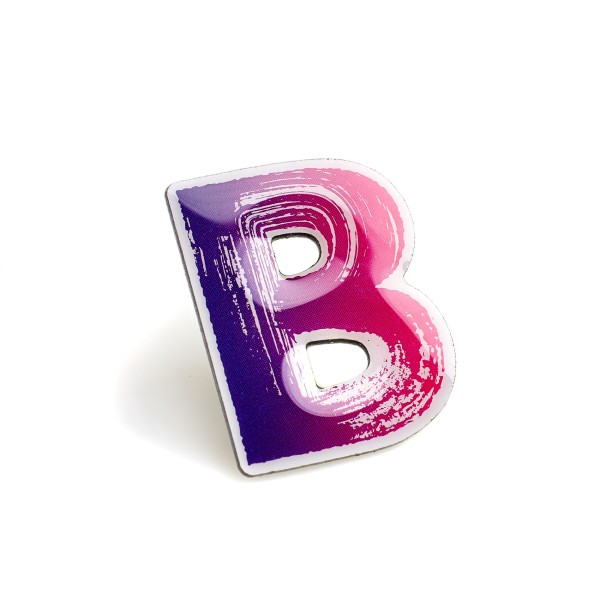 A capital letter B printed pin badge with a gradient purple and pink colour.