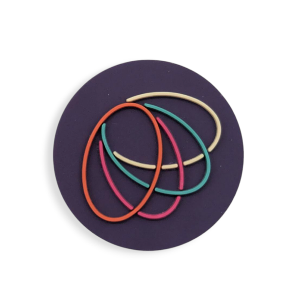 A purple circular bespoke PVC badge with multicoloured ovals in the middle.