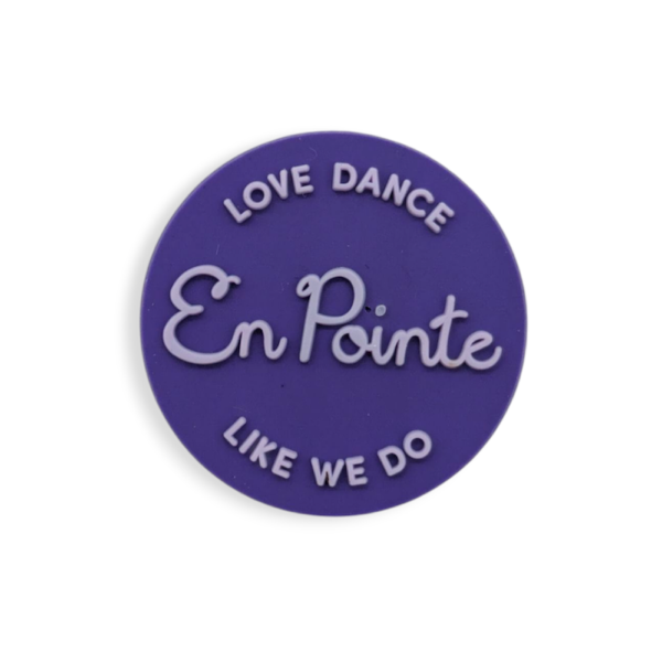 A purple circle soft PVC badge with the words
