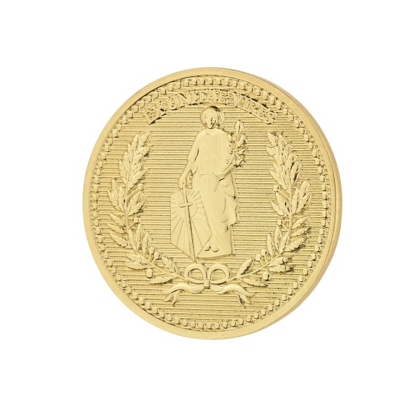 A gold plated custom coin with a intricate of a person's outline, designed for good luck.