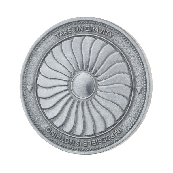 This thick challenge coin custom made with a large turbine and text around the edges.