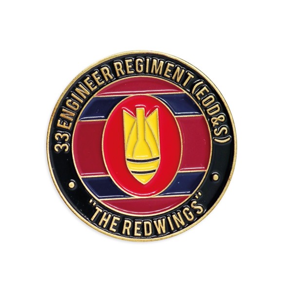 A colored enamel black and red challenge coin celebrating a military unit.