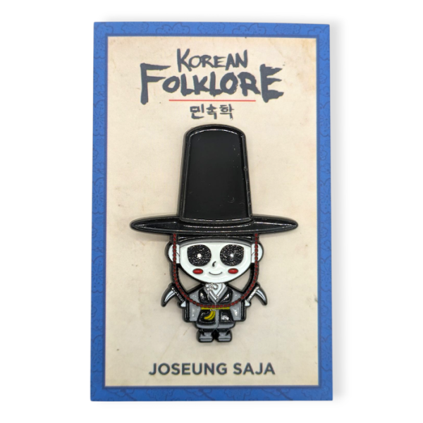 A soft enamel pin featuring a cartoon character from Korean Folklore, it's pinned to beige backing card with a blue outline.