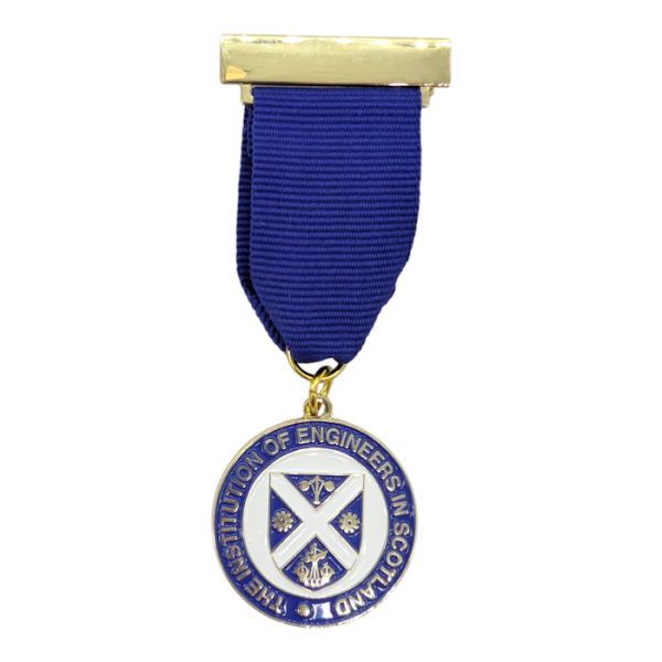 A soft enamel pin with a bar pin badge with a blue ribbon attached. There's a circular enamel medal at the bottom with a Scottish crest and the words