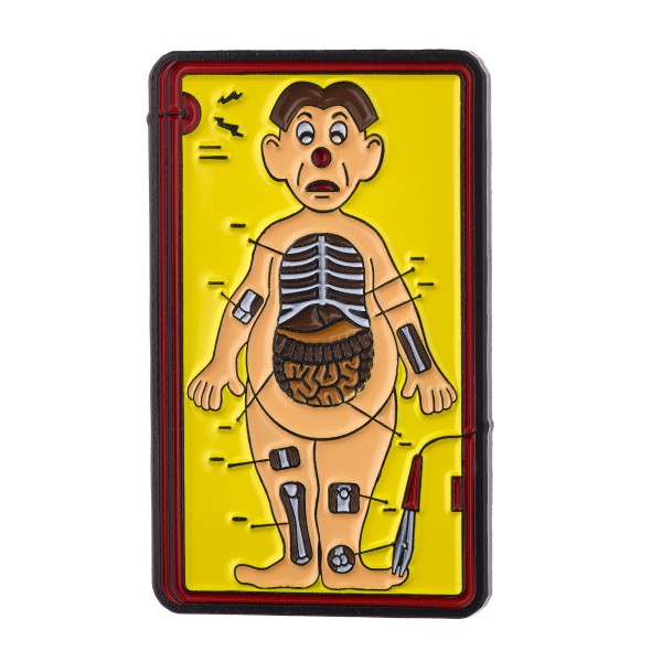 A large rectangular enamel pin that looks like the front of the box of the game Operation.