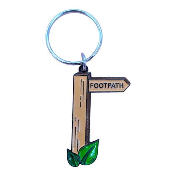 An illustrated soft enamel keyring showing a sign post that reads