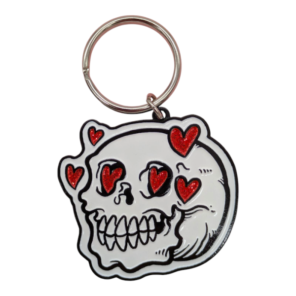 A white skull soft enamel keyring with love hears surrounding its red eyes.
