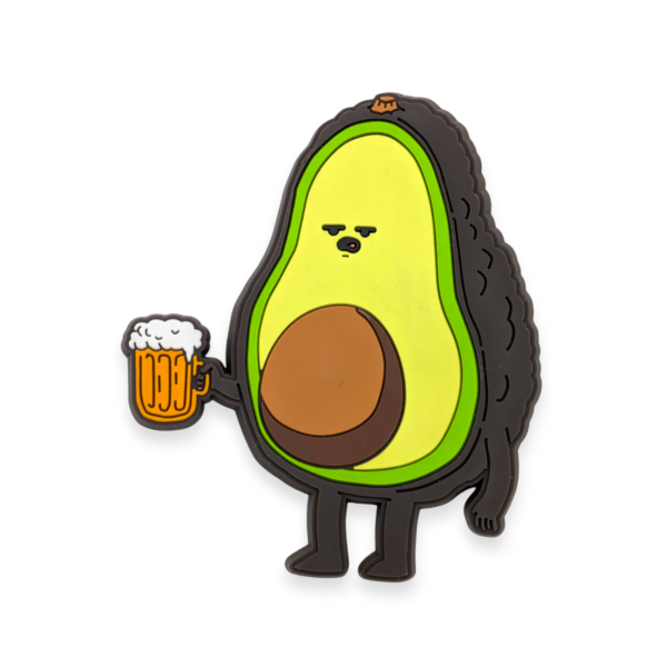 A custom PVC fridge magnet in the shape of a sad looking cartoon avocado holding a pint of beer.