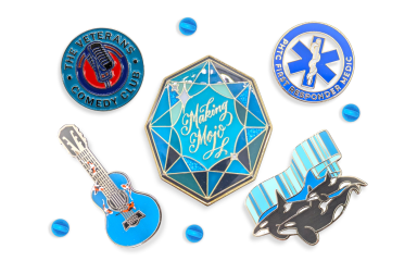 A collection of five pin badges that have blue hues to make a very appealing image.