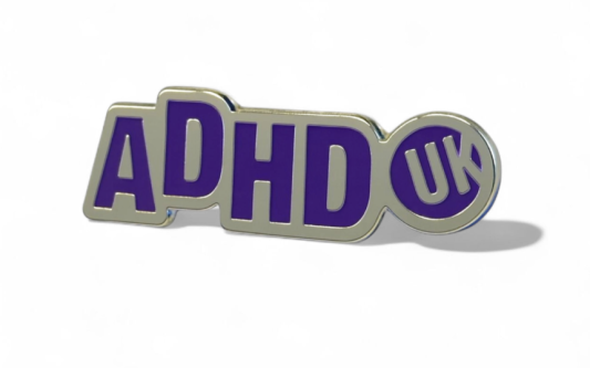 an ADHD UK awareness pin pin badge with silver plating and purple enamel.