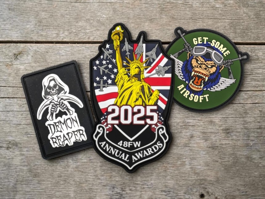 Collection of custom PVC patches including awards badge, airsoft logo and reaper design with vibrant colours and raised detailing.