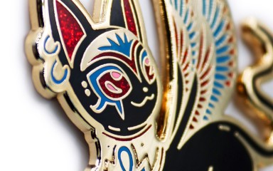 A close up of a beautiful cat pin badge with an Egyptian vibe.