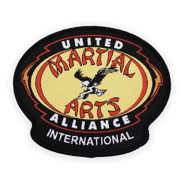 Oval woven patch with United Martial Arts Alliance International text and eagle graphic, stitched in bold colours, designed as a custom woven patch for martial arts organisations and uniforms.
