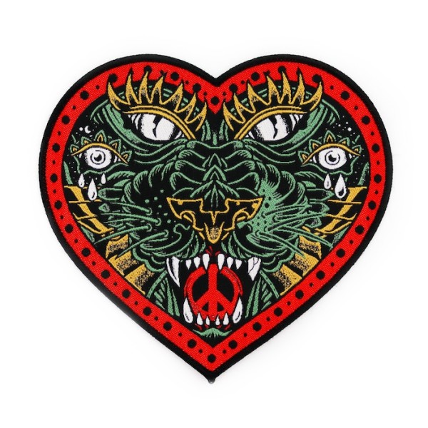 A custom patch in the shape of a love heart that contains an intricate tribal design of a panther.