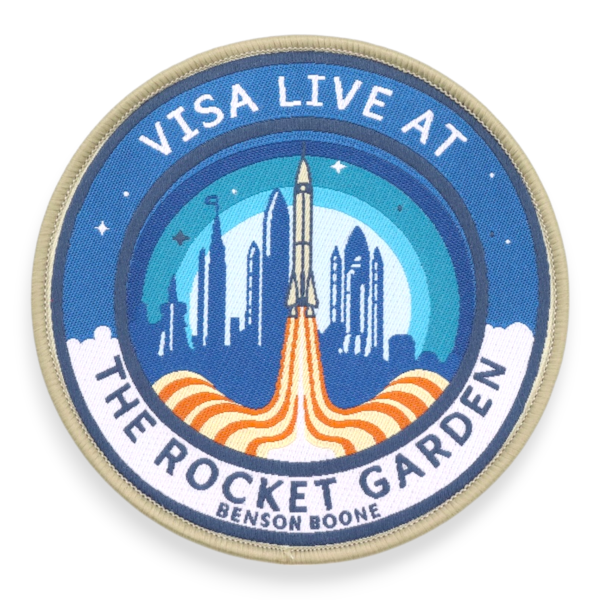 A Benson Boone Rocket Garden themed printed patch with launch illustration and layered blue background, example of custom festival patches.